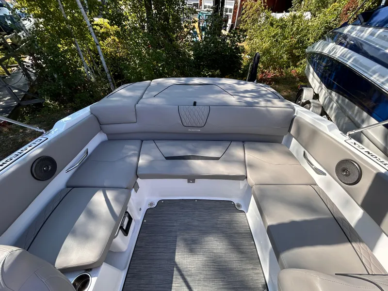 Slide: The Image of 2024 Glastron GX 215 boat interior with spacious seating and modern design. - 18