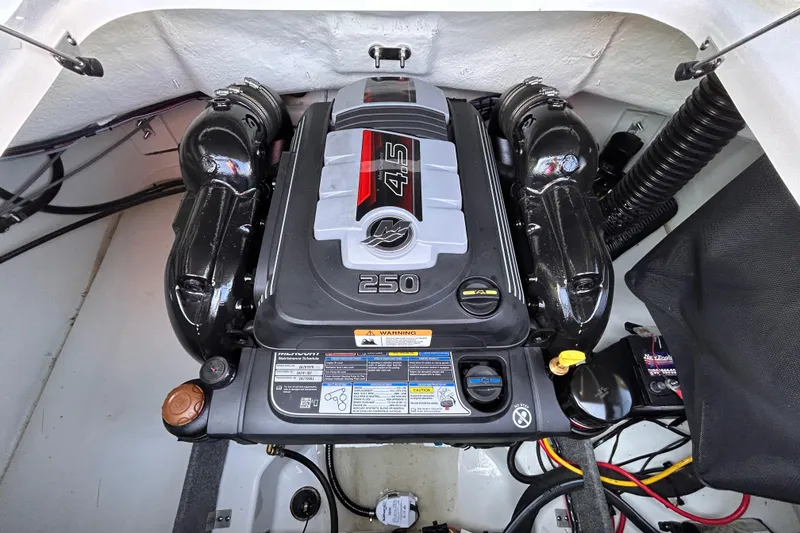 Slide: The Image of 2024 Glastron GX 215 engine compartment showcasing a powerful 4.5L 250 horsepower engine. - 19