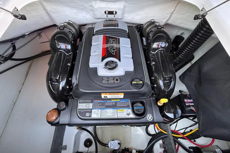 Slide: The Image of 2024 Glastron GX 215 engine compartment with a powerful 4.5L 250 HP engine. - 20