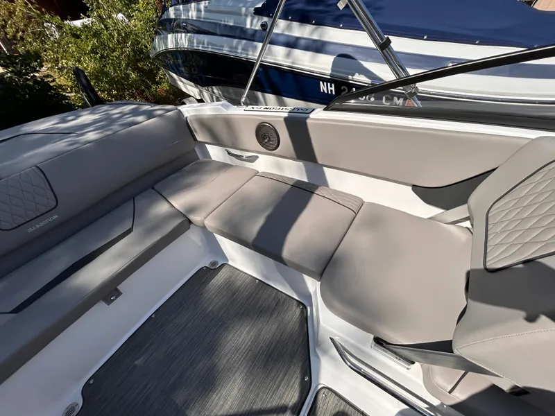 Slide: The Image of 2024 Glastron GX 215 boat interior with gray seating and modern design. - 22