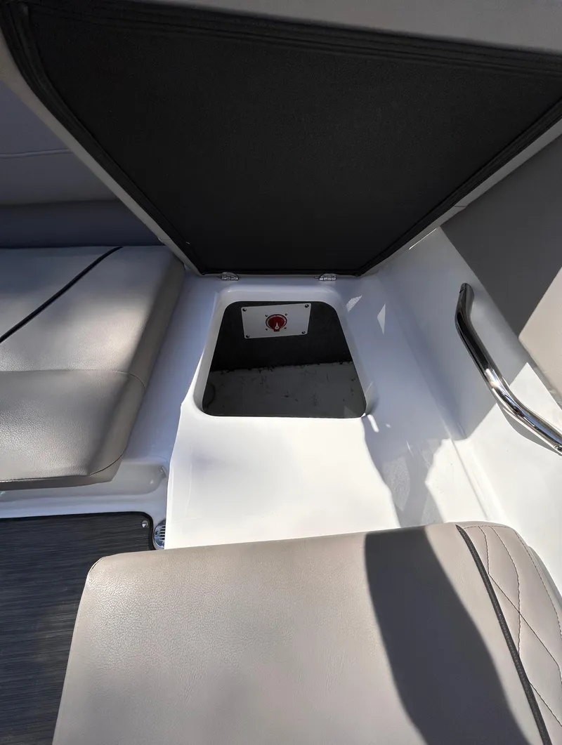 Slide: The Image of 2024 Glastron GX 215 interior seating with storage compartment. - 23
