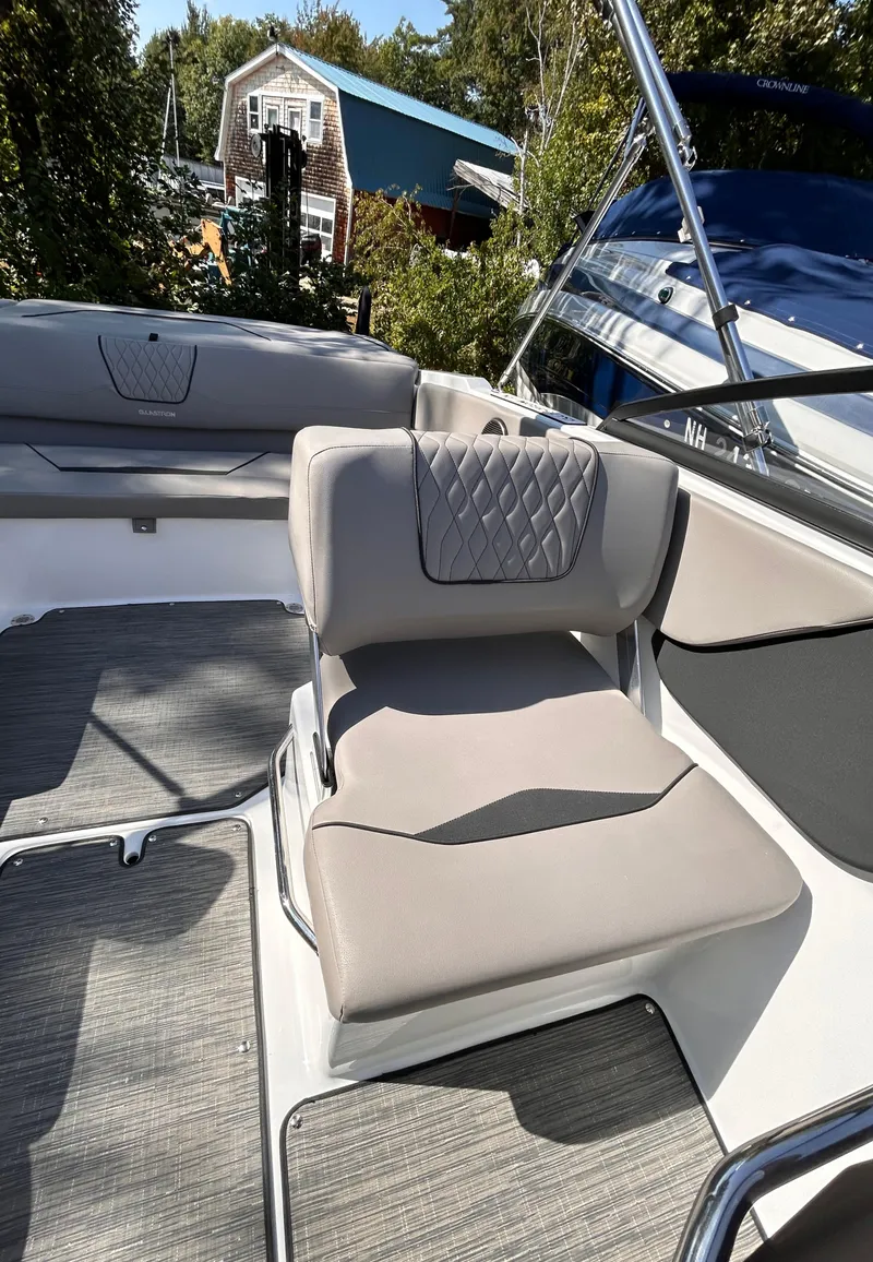 Slide: The Image of 2024 Glastron GX 215 boat interior with cushioned seating and modern design. - 25