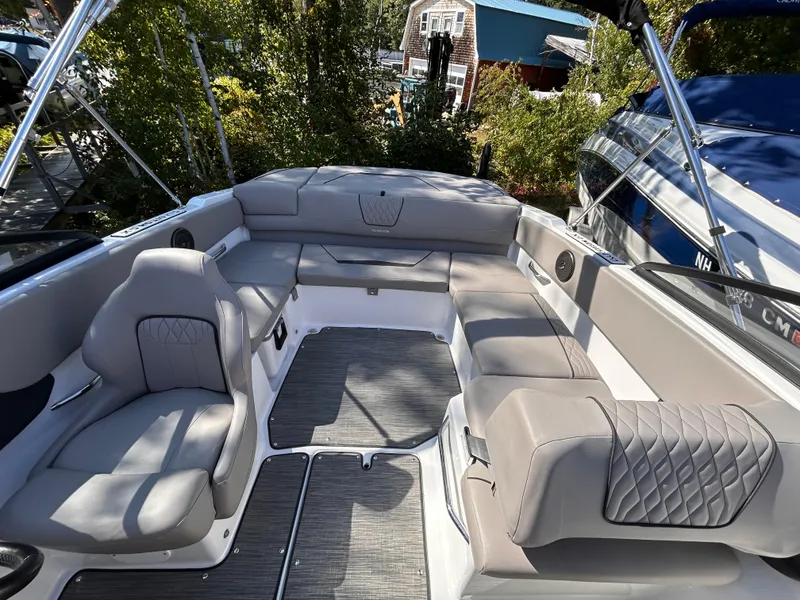 Slide: The Image of 2024 Glastron GX 215 boat interior with spacious seating and modern design. - 26
