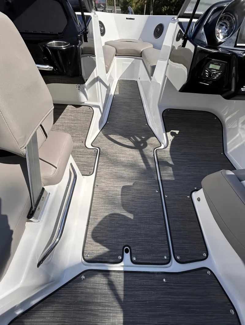 Slide: The Image of 2024 Glastron GX 215 boat interior with modern seating and sleek flooring design. - 30