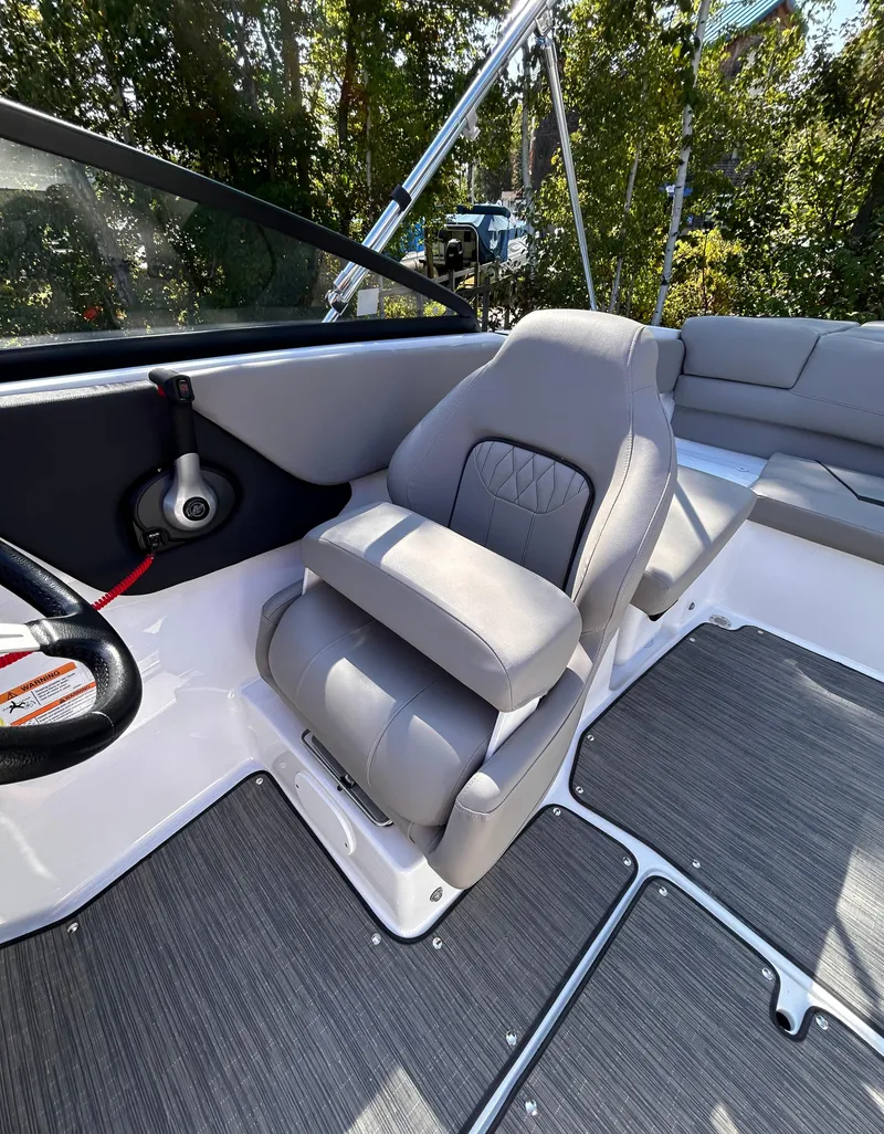 Slide: The Image of 2024 Glastron GX 215 boat interior with gray seating and modern design. - 35