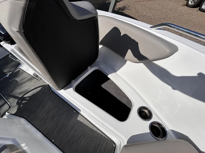 Slide: The Image of 2024 Glastron GX 215 boat interior with storage compartment and cup holders. - 38
