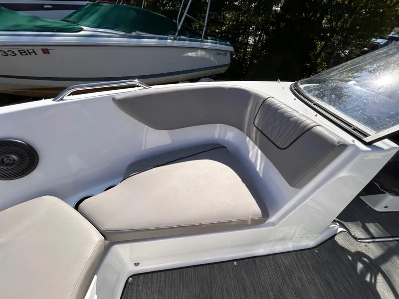 Slide: The Image of 2024 Glastron GX 215 boat interior with cushioned seating and sleek design. - 39