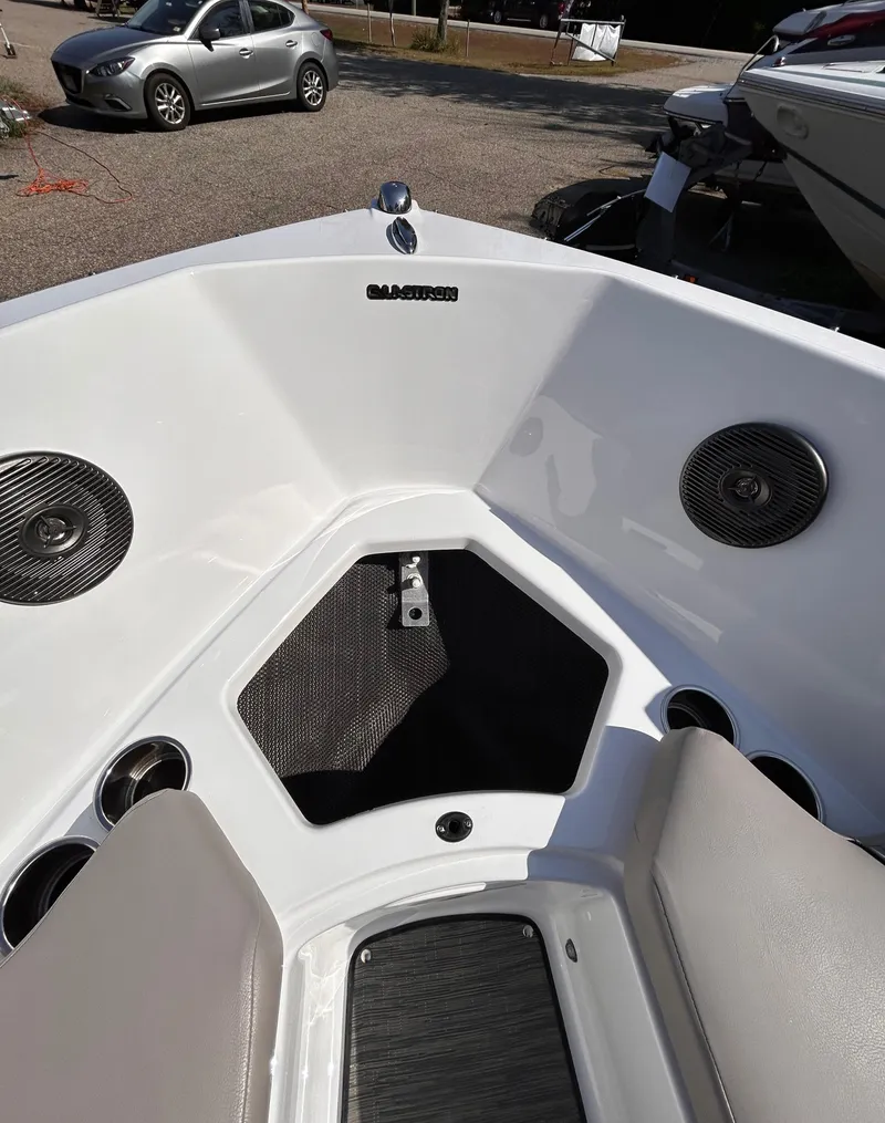 Slide: The Image of 2024 Glastron GX 215 boat interior with speakers and seating. - 42