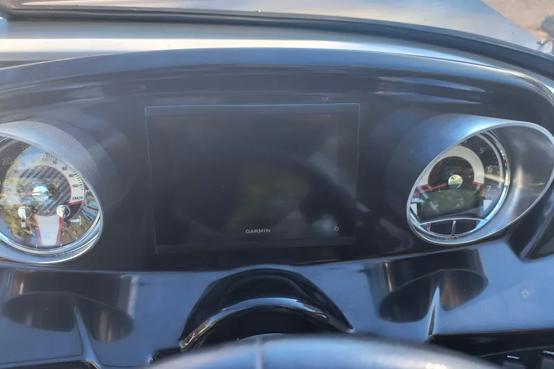 Slide: The Image of Dashboard of 2024 Glastron GX 215 boat with Garmin display and gauges. - 10