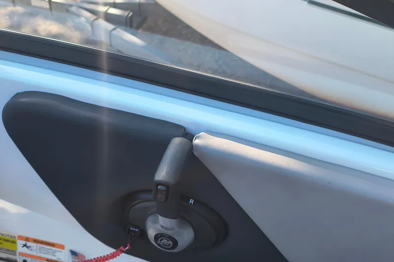 Slide: The Image of 2024 Glastron GX 215 boat throttle control and handle detail. - 11