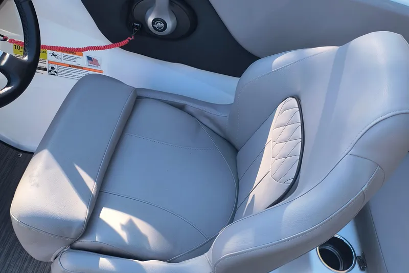 Slide: The Image of 2024 Glastron GX 215 boat seat with gray upholstery and cup holder. - 12