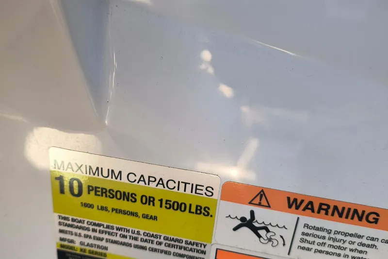 Slide: The Image of 2024 Glastron GX 215 capacity warning label, maximum 10 persons or 1500 lbs. - 13