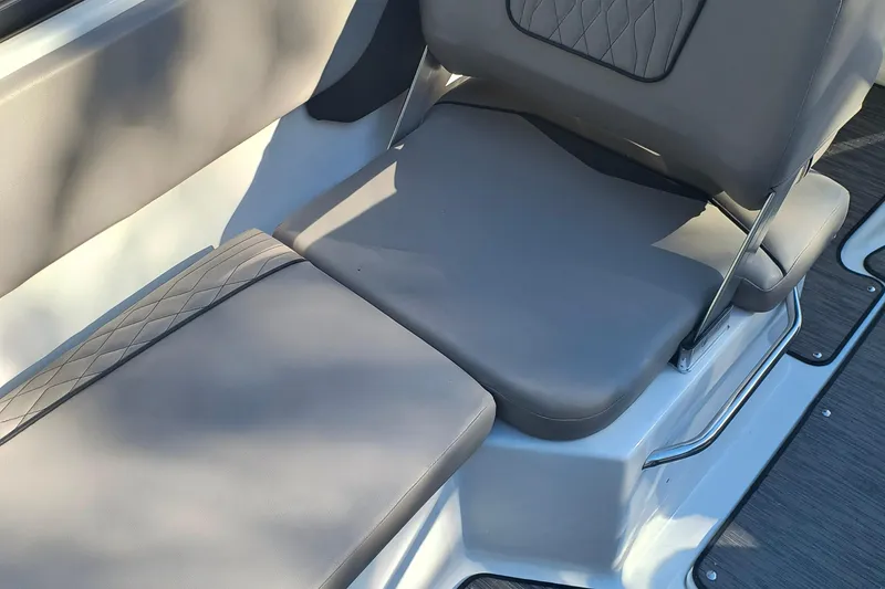 Slide: The Image of 2024 Glastron GX 215 boat seating with gray upholstery and diamond stitching. - 14