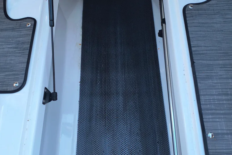 Slide: The Image of 2024 Glastron GX 215 boat interior with textured flooring and sleek design elements. - 18