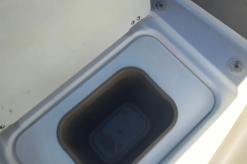 Slide: The Image of Storage compartment in 2024 Glastron GX 215 boat, featuring a clean, white interior design. - 23