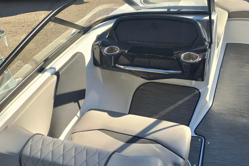 Slide: The Image of 2024 Glastron GX 215 boat interior with seating and cup holders. - 4