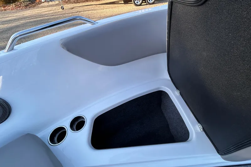 Slide: The Image of 2024 Glastron GX 215 boat interior storage compartment with cup holders. - 15