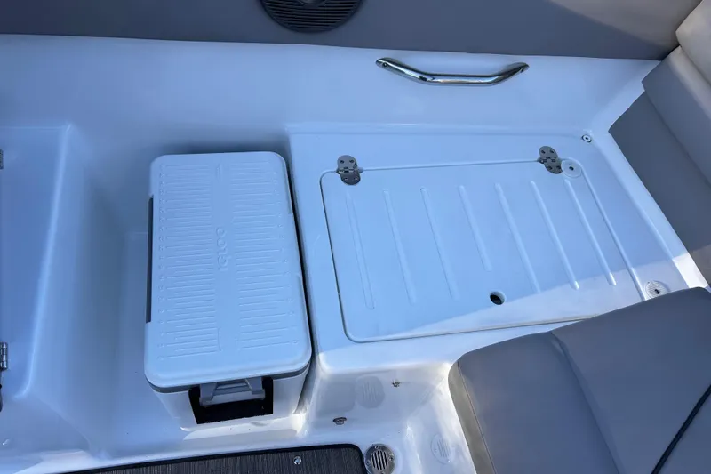 Slide: The Image of 2024 Glastron GX 215 boat interior with storage compartments and cooler. - 20