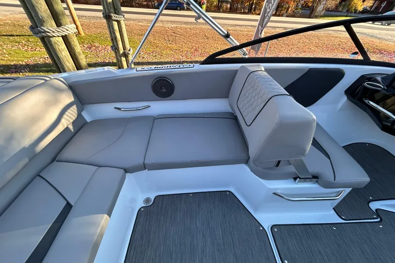 Slide: The Image of 2024 Glastron GX 215 boat interior with gray seating and modern design. - 25
