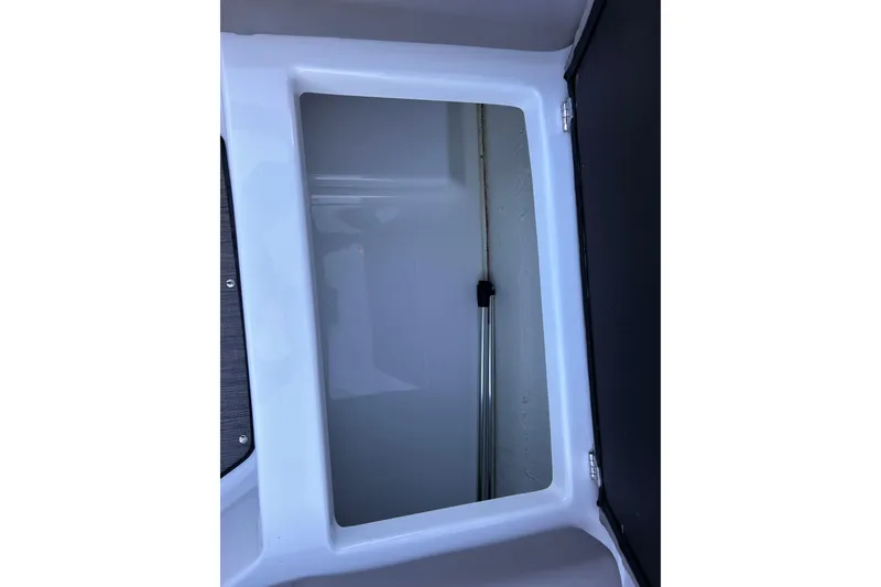 Slide: The Image of 2024 Glastron GX 215 boat storage compartment, open and empty. - 28
