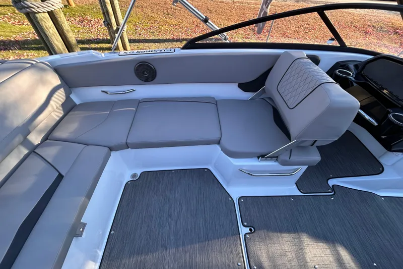 Slide: The Image of 2024 Glastron GX 215 boat interior with gray seating and modern design. - 29