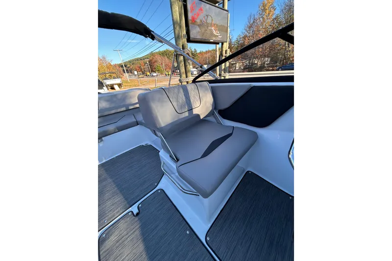 Slide: The Image of 2024 Glastron GX 215 boat interior with gray seating and sleek design. - 34