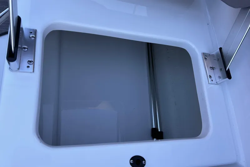 Slide: The Image of 2024 Glastron GX 215 boat storage compartment with stainless steel hinges. - 35