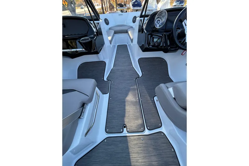 Slide: The Image of 2024 Glastron GX 215 boat interior with sleek seating and modern dashboard design. - 38
