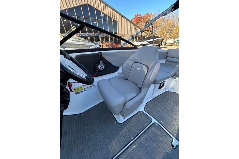 Slide: The Image of 2024 Glastron GX 215 boat interior with gray seating and modern dashboard. - 46