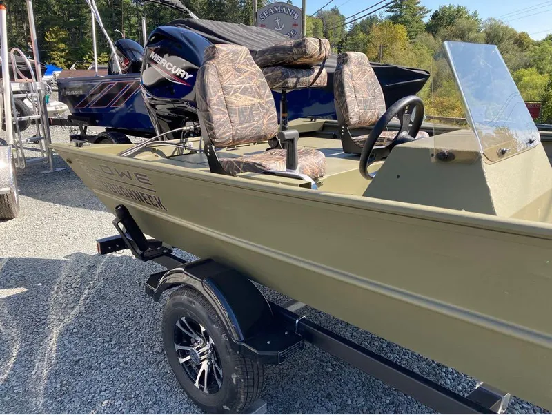 Slide: The Image of 2024 Lowe Roughneck RX1660 SC boat with Mercury engine on a trailer, displayed outdoors. - 3