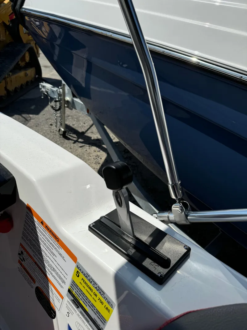 Slide: The Image of 2025 Scarab 165 ID boat throttle control and safety warnings. - 12