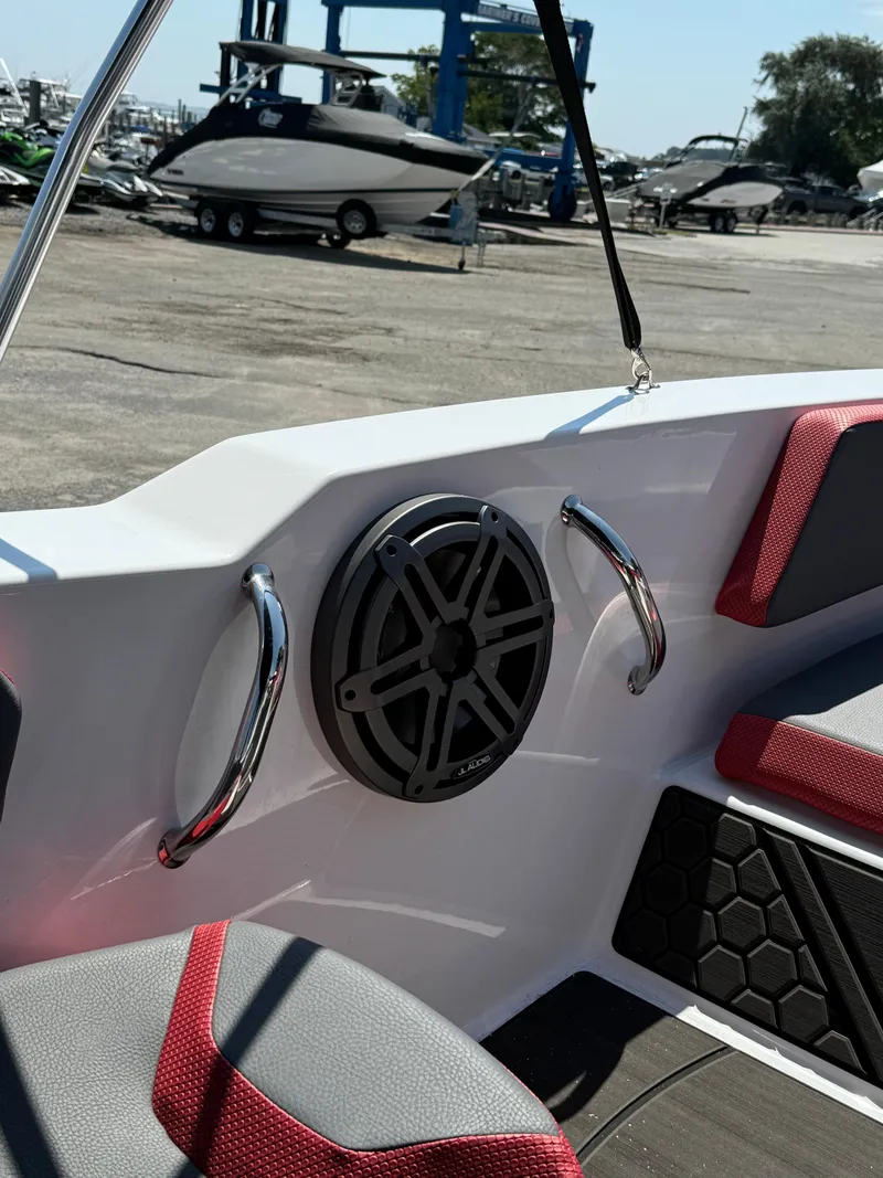 Slide: The Image of 2025 Scarab 165 ID boat interior with speaker and red-accented seating. - 13