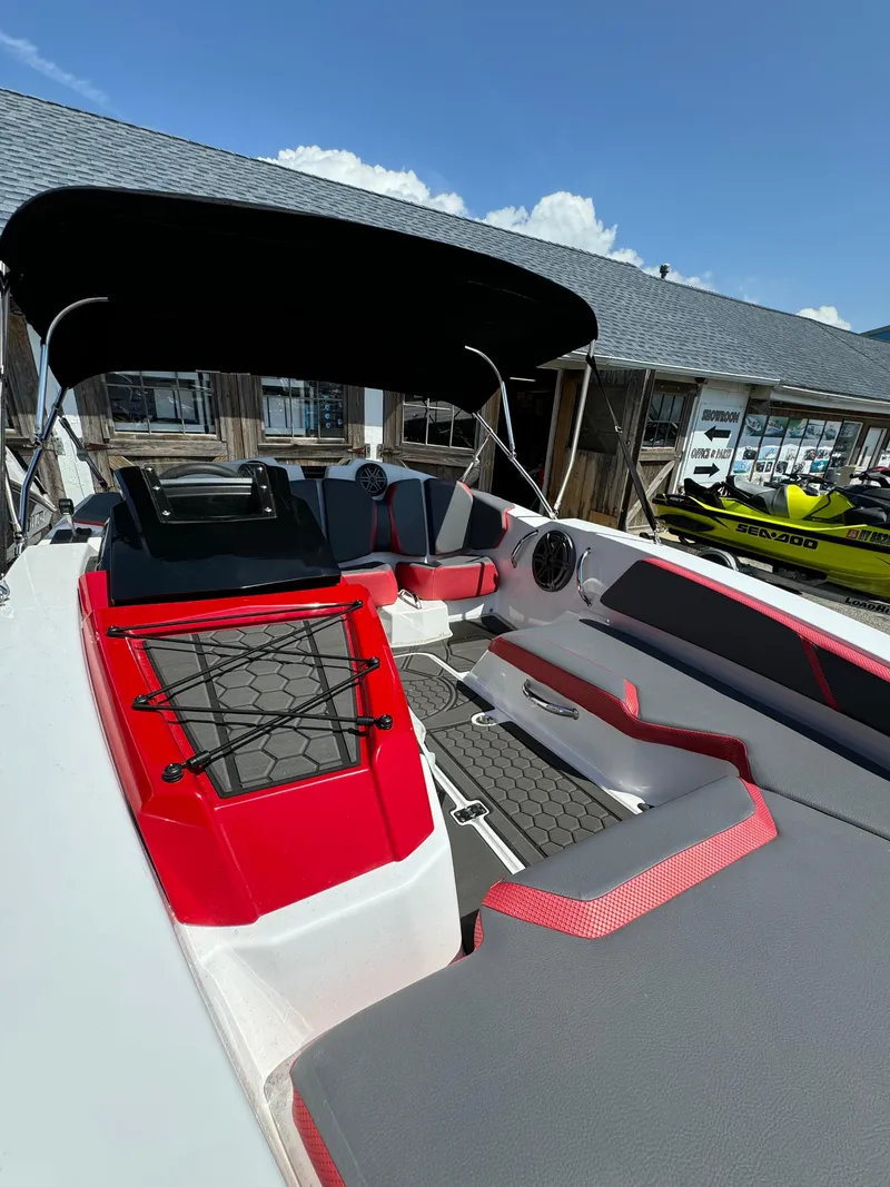 Slide: The Image of 2025 Scarab 165 ID boat with sleek design, red and gray interior, and canopy. - 17