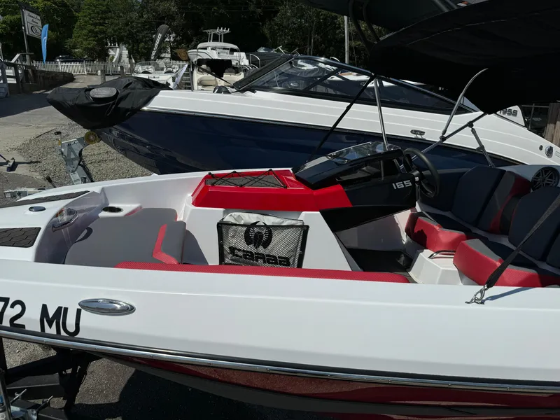 Slide: The Image of 2025 Scarab 165 ID boat with red and white interior, docked outdoors. - 4
