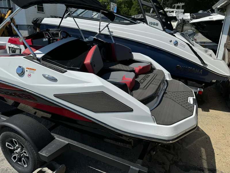 Slide: The Image of 2025 Scarab 165 ID boat with sleek design and red accents on a trailer. - 6