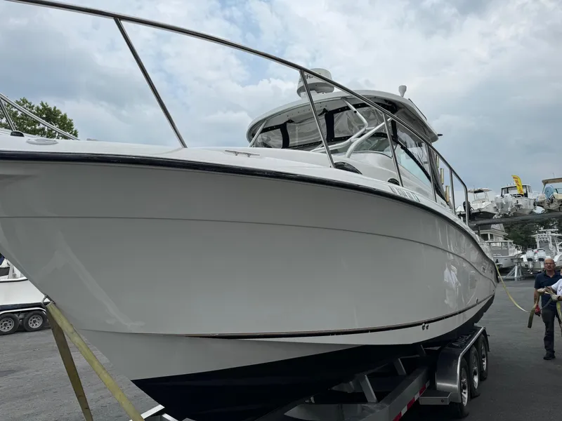 The Image of 2004 Seaswirl Striper 2901 Walkaround O/B boat on trailer, cloudy sky background. - 0