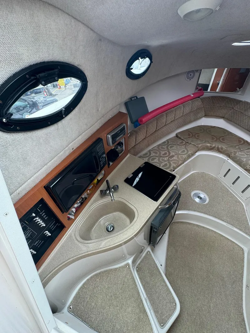 Slide: The Image of 2004 Seaswirl Striper 2901 Walkaround O/B cabin interior with sink and seating area. - 8