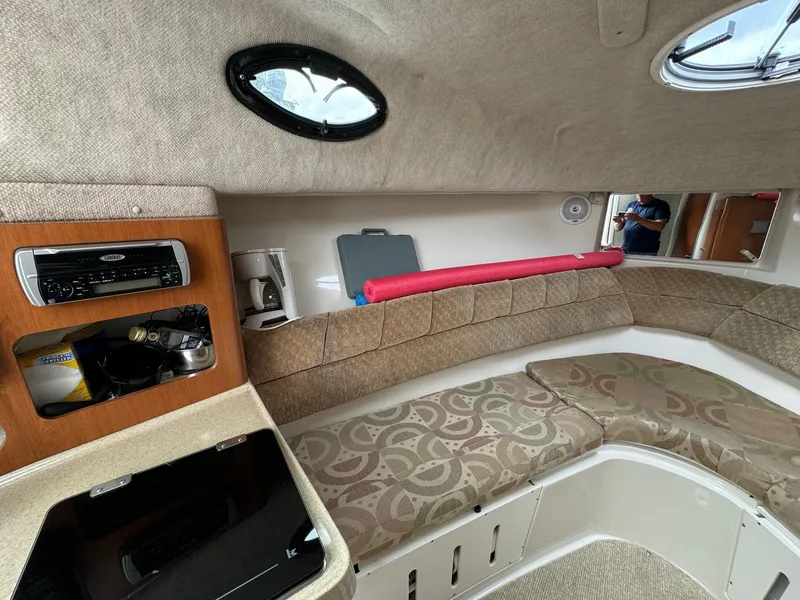 Slide: The Image of 2004 Seaswirl Striper 2901 Walkaround cabin interior with seating and storage. - 9