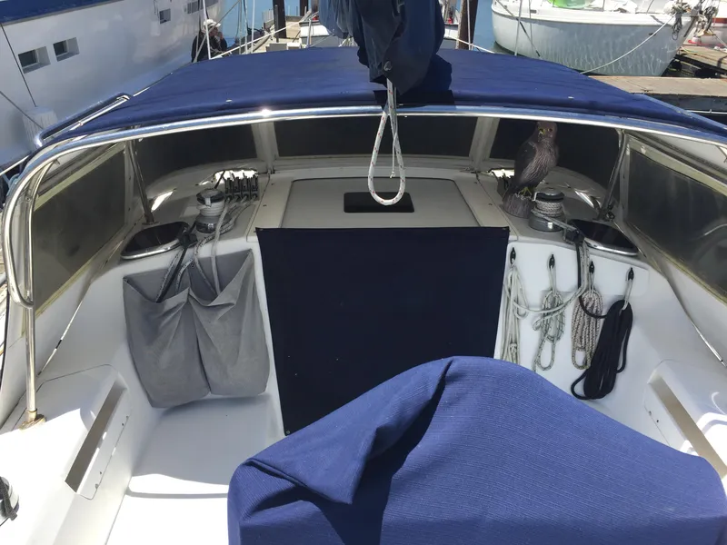 Slide: The Image of 2005 Catalina 34 Mk II sailboat cockpit with blue canvas cover and organized ropes. - 12