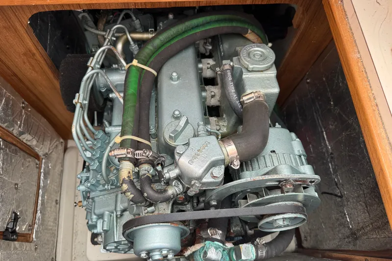 Slide: The Image of Engine of a 2005 Catalina 34 Mk II sailboat, featuring hoses and mechanical components. - 13