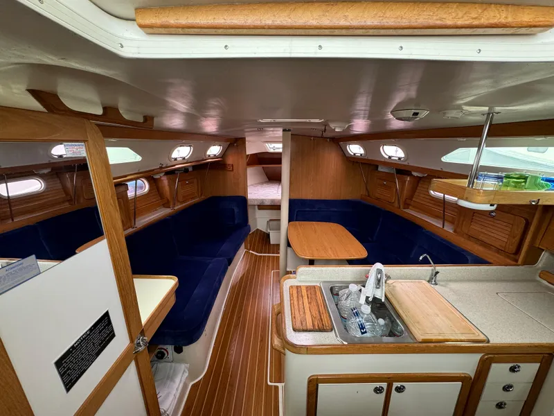 Slide: The Image of Interior of 2005 Catalina 34 Mk II sailboat with wood accents and blue seating. - 19