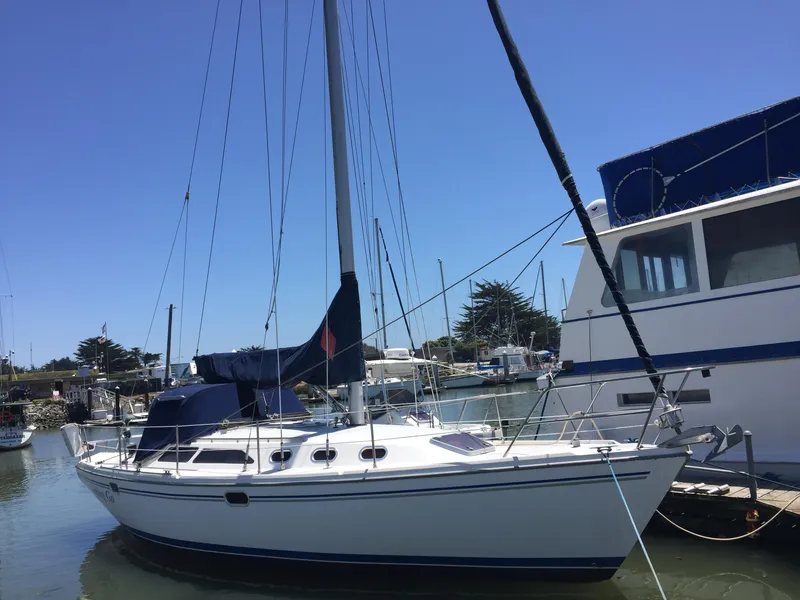 Slide: The Image of 2005 Catalina 34 Mk II sailboat docked in a marina under clear blue skies. - 2