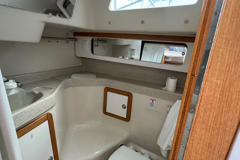 Slide: The Image of 2005 Catalina 34 Mk II yacht bathroom with sink, mirror, and storage cabinets. - 21