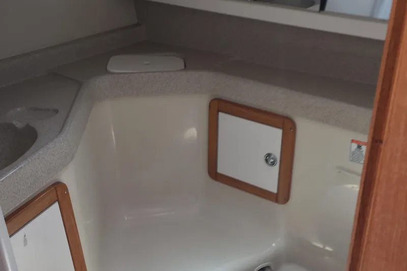 Slide: The Image of Interior of a 2005 Catalina 34 Mk II sailboat, featuring a compact bathroom area. - 22