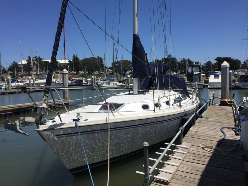 Slide: The Image of 2005 Catalina 34 Mk II sailboat docked at a marina under clear blue skies. - 3