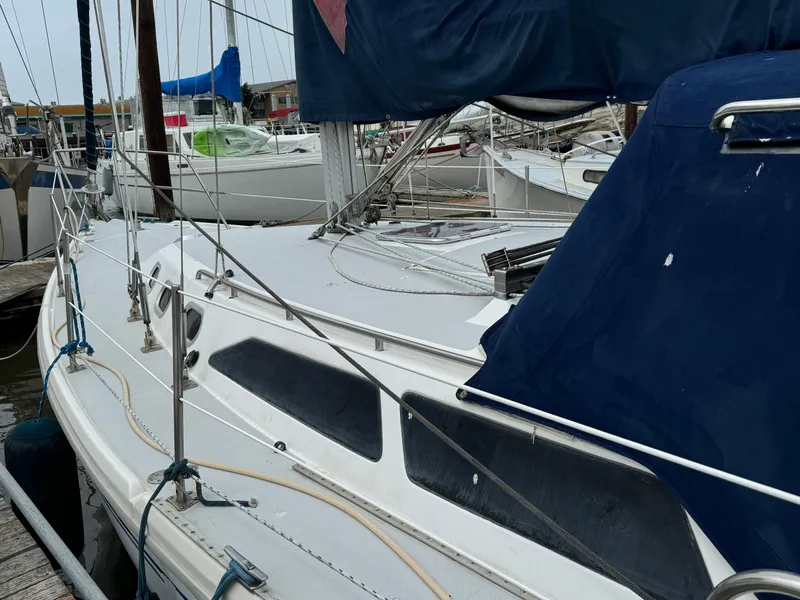 Slide: The Image of 2005 Catalina 34 Mk II sailboat docked at marina, featuring sleek design and blue covers. - 4