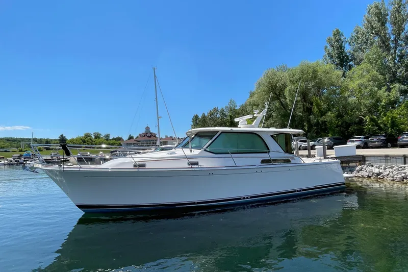 Slide: The Image of 2024 Sabre 43 Salon Express yacht docked on a sunny day. - 10