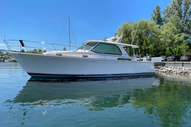 Slide: The Image of 2024 Sabre 43 Salon Express yacht docked on a sunny day. - 11