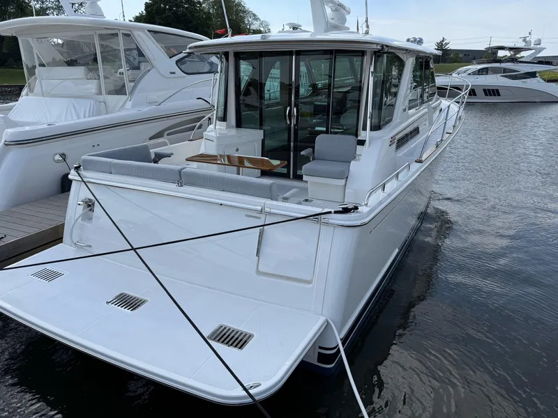 Slide: The Image of 2024 Sabre 43 Salon Express yacht docked on calm water. - 16