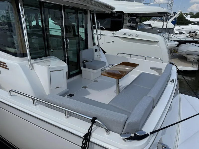Slide: The Image of 2024 Sabre 43 Salon Express yacht with outdoor seating and table at marina. - 17